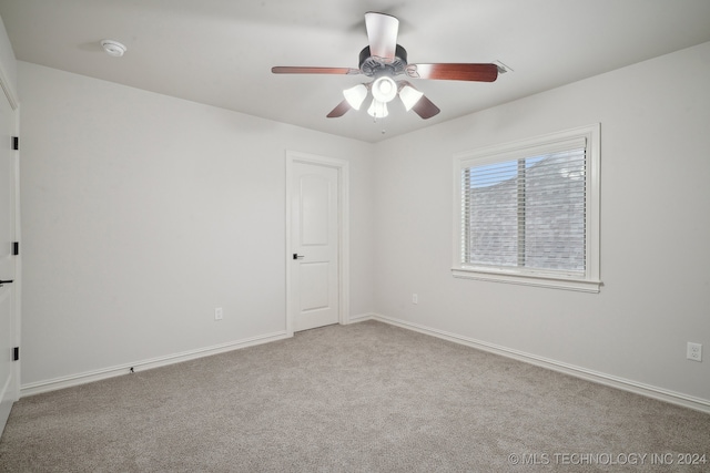 spare room featuring ceiling fan and light colored carpet