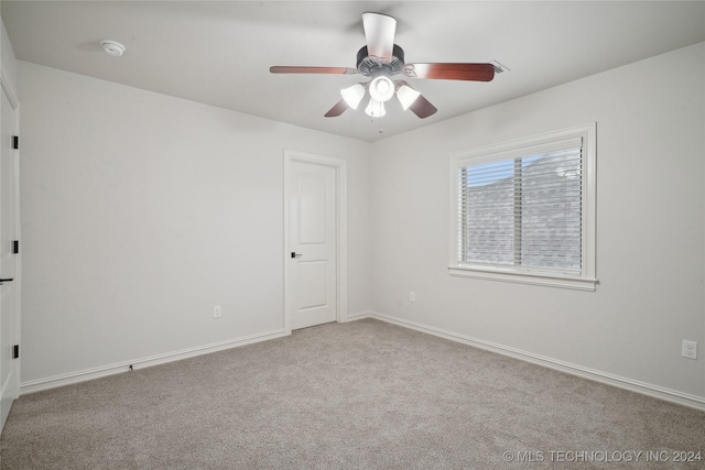 unfurnished room with ceiling fan and light colored carpet