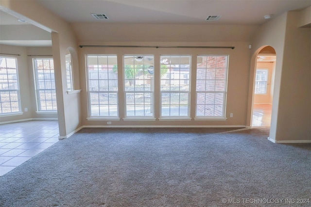 tiled spare room featuring ceiling fan