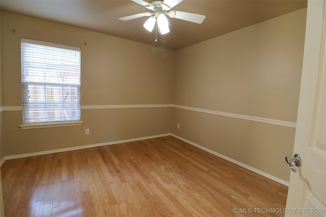 empty room featuring light wood-type flooring and ceiling fan