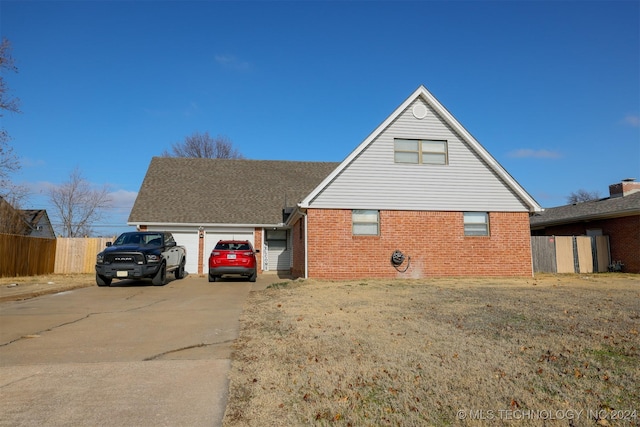 view of front of home with a garage and a front lawn