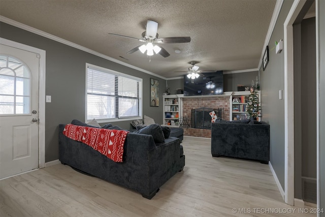 living room with plenty of natural light, light hardwood / wood-style floors, crown molding, and a brick fireplace