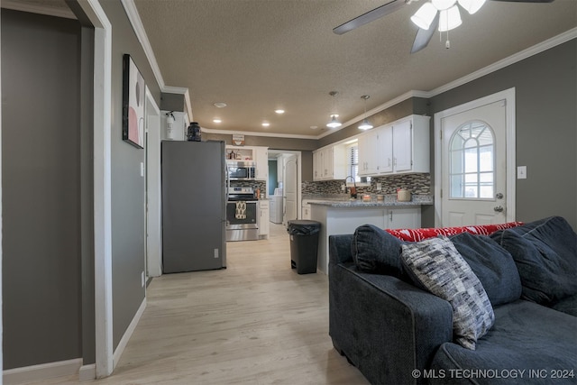 living room featuring a textured ceiling, light hardwood / wood-style flooring, ceiling fan, and crown molding