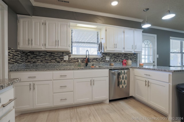 kitchen featuring dishwasher, white cabinetry, plenty of natural light, and sink