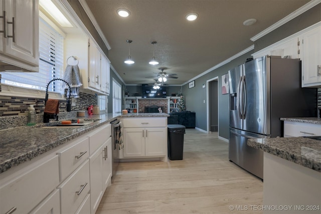 kitchen with white cabinetry, sink, crown molding, and appliances with stainless steel finishes