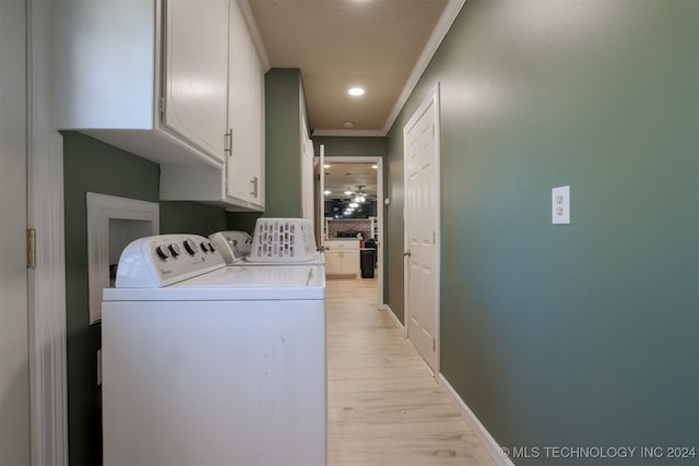 laundry area with washer and dryer, light hardwood / wood-style flooring, and crown molding