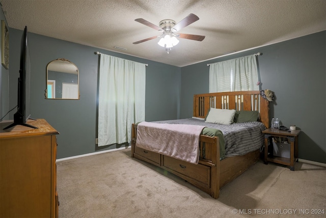 bedroom with light carpet, a textured ceiling, and ceiling fan