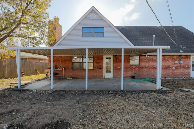 back of property with a patio