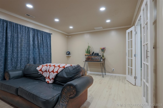 sitting room with light hardwood / wood-style floors, ornamental molding, and french doors