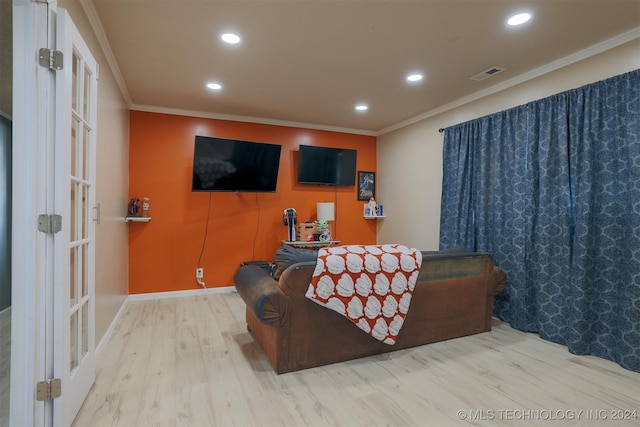 living room featuring hardwood / wood-style flooring and crown molding