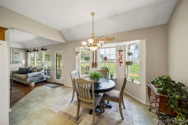 dining room featuring lofted ceiling and a notable chandelier