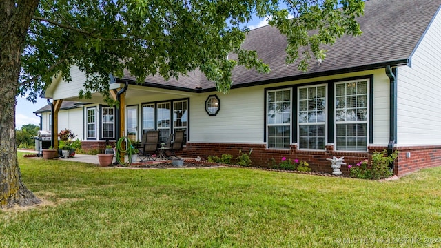 rear view of property with a yard