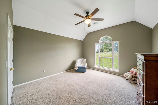 interior space featuring light colored carpet, vaulted ceiling, and ceiling fan