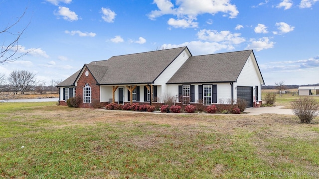 view of front facade with covered porch, a garage, and a front lawn