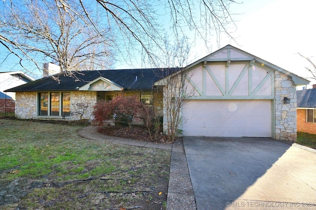 view of front of house with a front yard and a garage