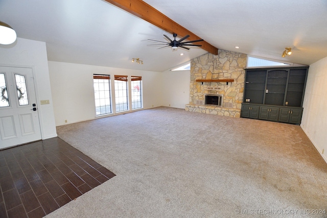 unfurnished living room featuring a fireplace, carpet, lofted ceiling with beams, and ceiling fan