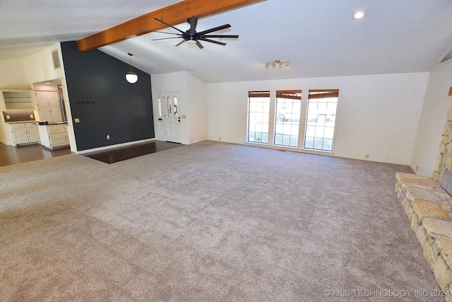 unfurnished living room featuring dark colored carpet, lofted ceiling with beams, and ceiling fan