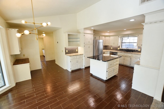 kitchen with a center island, sink, stainless steel appliances, and dark wood-type flooring