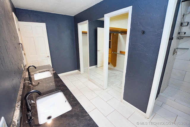 bathroom featuring tile patterned floors, vanity, and walk in shower