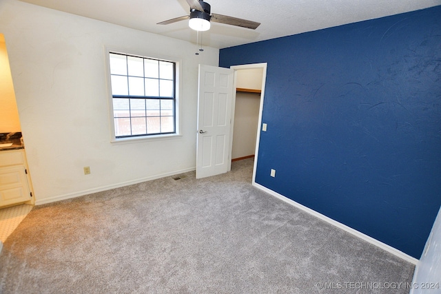 unfurnished bedroom featuring carpet flooring and ceiling fan