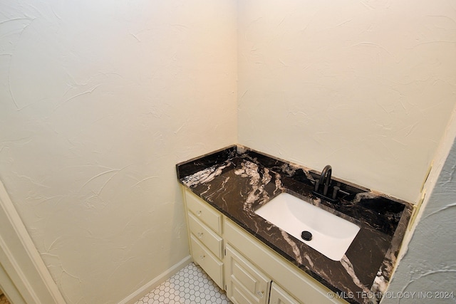 bathroom with tile patterned floors and vanity