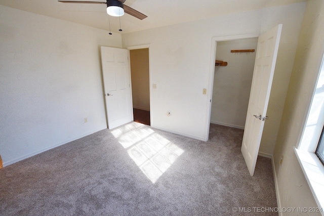 unfurnished bedroom with ceiling fan, light colored carpet, and a closet