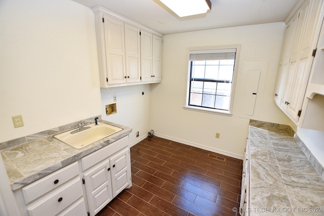 laundry room with sink, cabinets, hookup for an electric dryer, dark hardwood / wood-style floors, and hookup for a washing machine