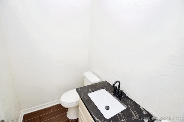 bathroom with sink, wood-type flooring, and toilet