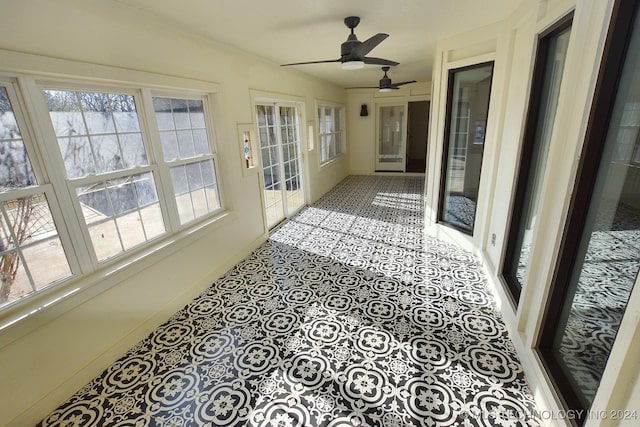 sunroom / solarium featuring ceiling fan