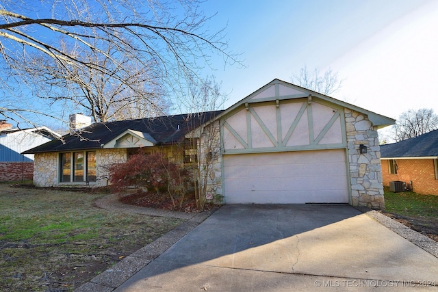 view of front of property featuring cooling unit and a garage