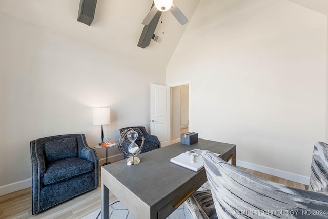 office space with ceiling fan, high vaulted ceiling, and light hardwood / wood-style floors