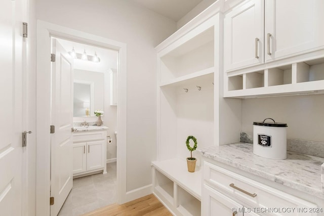 mudroom featuring light wood-type flooring and sink