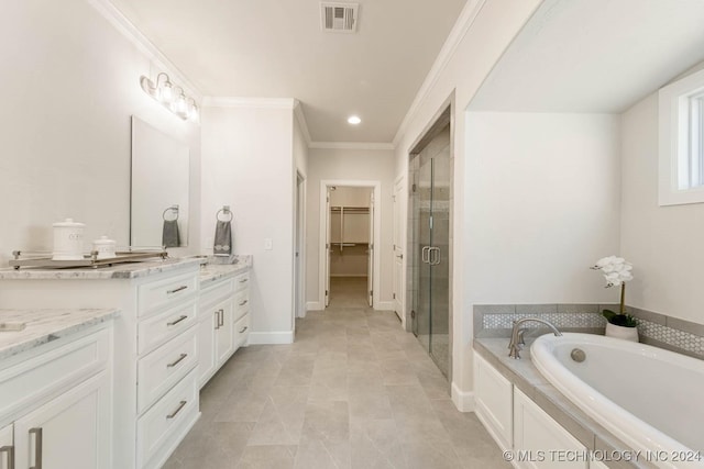 bathroom featuring tile patterned floors, vanity, separate shower and tub, and ornamental molding