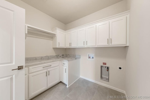 clothes washing area featuring hookup for a washing machine, cabinets, and hookup for an electric dryer