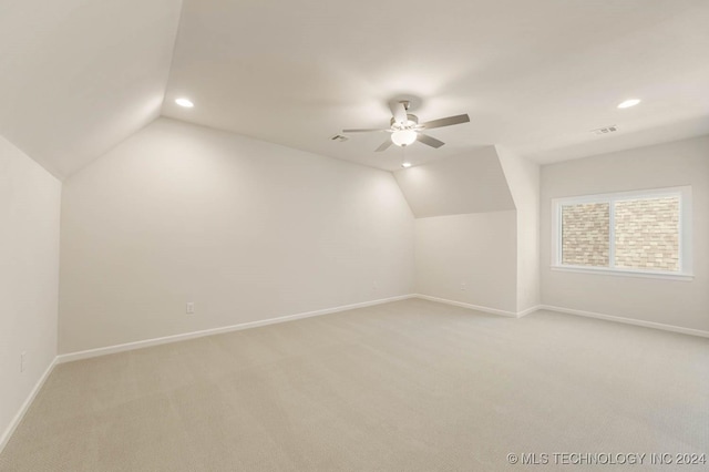 bonus room with ceiling fan, light carpet, and vaulted ceiling