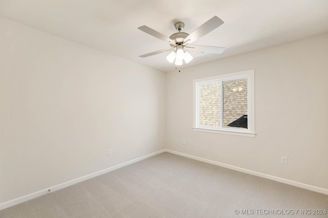 unfurnished room featuring ceiling fan and carpet floors