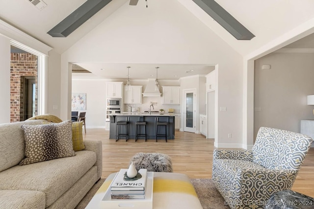 living room featuring light hardwood / wood-style floors and high vaulted ceiling