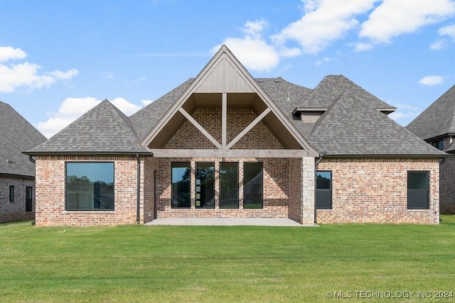 rear view of property with a yard