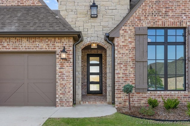 doorway to property with a garage