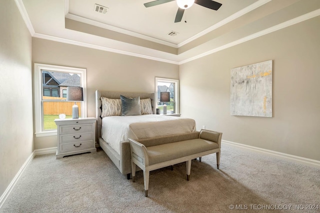 bedroom with light carpet, a raised ceiling, ceiling fan, and ornamental molding