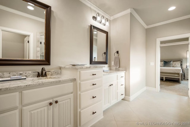 bathroom featuring tile patterned floors, crown molding, and vanity