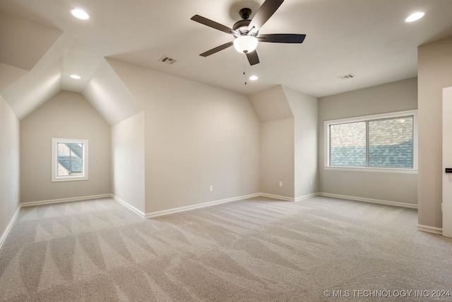 bonus room with light carpet, ceiling fan, and lofted ceiling