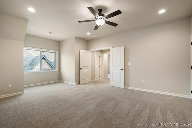 unfurnished bedroom featuring ceiling fan and light carpet