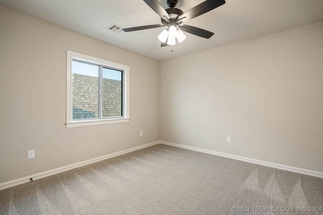 carpeted spare room featuring ceiling fan