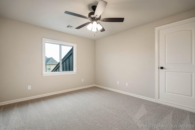 empty room with carpet and ceiling fan