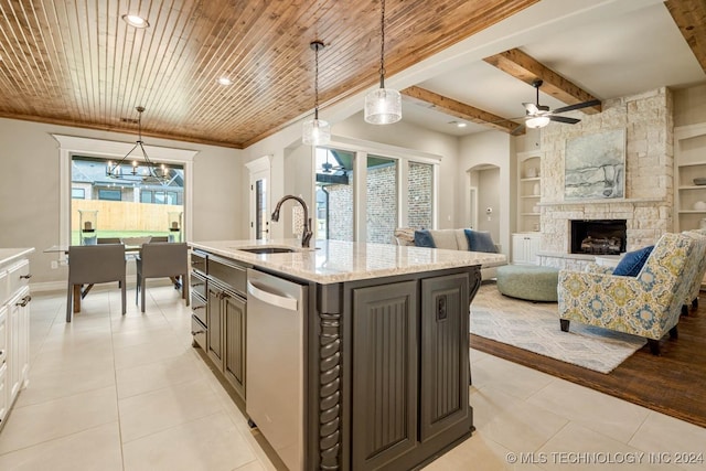 kitchen featuring built in shelves, a healthy amount of sunlight, decorative light fixtures, dishwasher, and white cabinetry