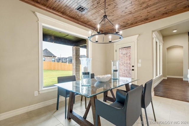 dining room featuring light tile patterned floors, a wealth of natural light, a notable chandelier, and wood ceiling