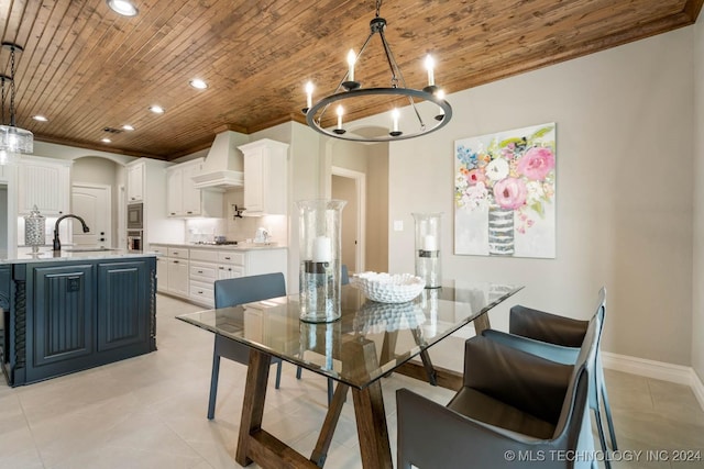 tiled dining space featuring sink, wooden ceiling, and a notable chandelier