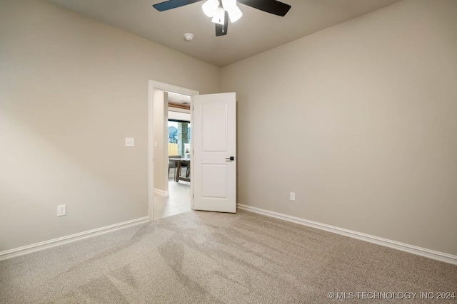 unfurnished room featuring ceiling fan and light colored carpet