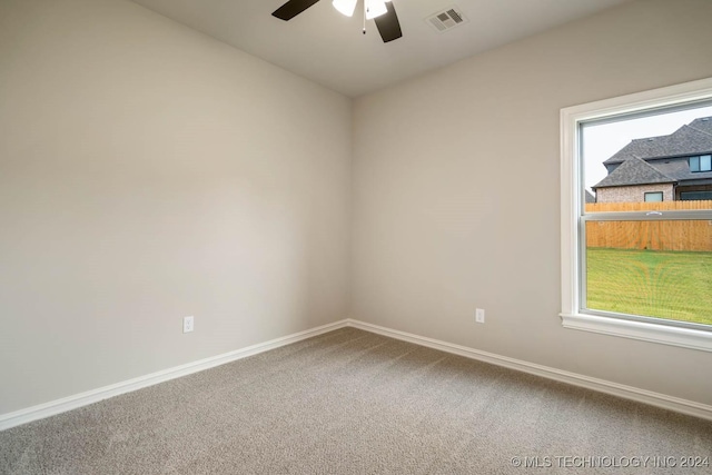 empty room with ceiling fan and carpet